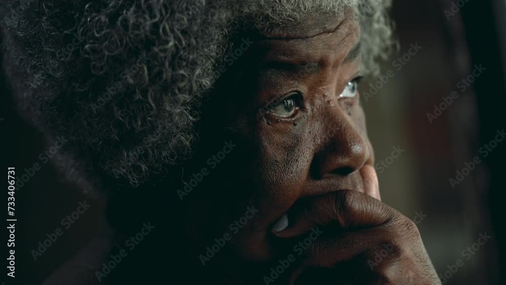Contemplative African American elderly woman gazing out in the distance in deep mental reflection. One black lady thoughtful expression pondering solution