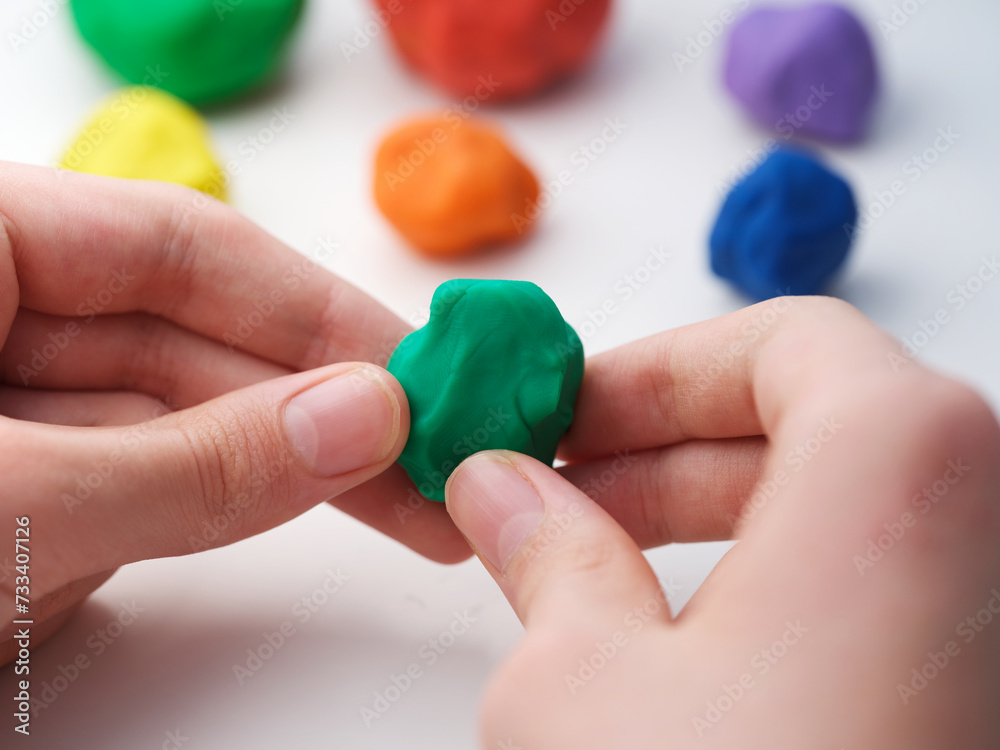 A young boy playing with play clay. Close up.