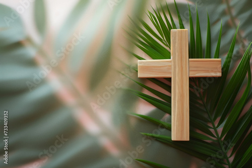 Palm Sunday background Wooden cross and palm leaves lying on neutral background with copy space for text. Christianity, faith, religious, Holy Week concept photo