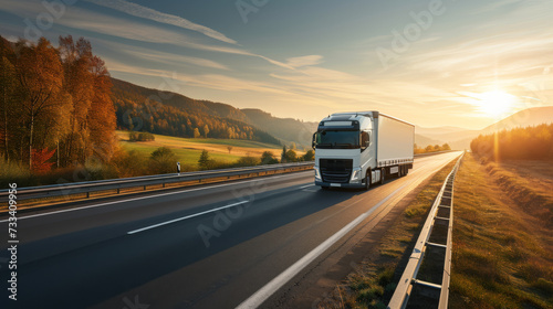 semi-truck is driving on a highway with motion blur, indicating speed, during a sunny autumn day with colorful trees on the side of the road.