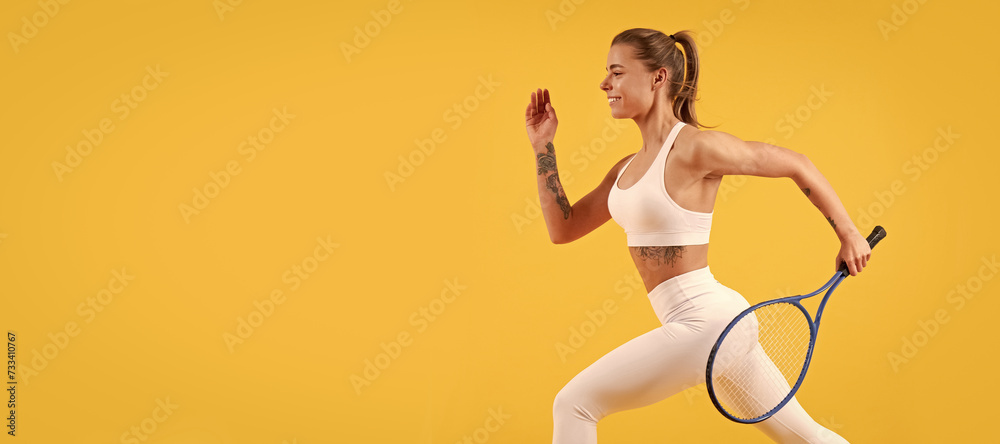 happy tennis player running with racket on yellow background, badminton. Woman isolated face portrait, banner with mock up copyspace.