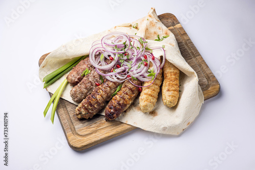 Delicious Lyulya kebab on a wooden board. Close-up  photo