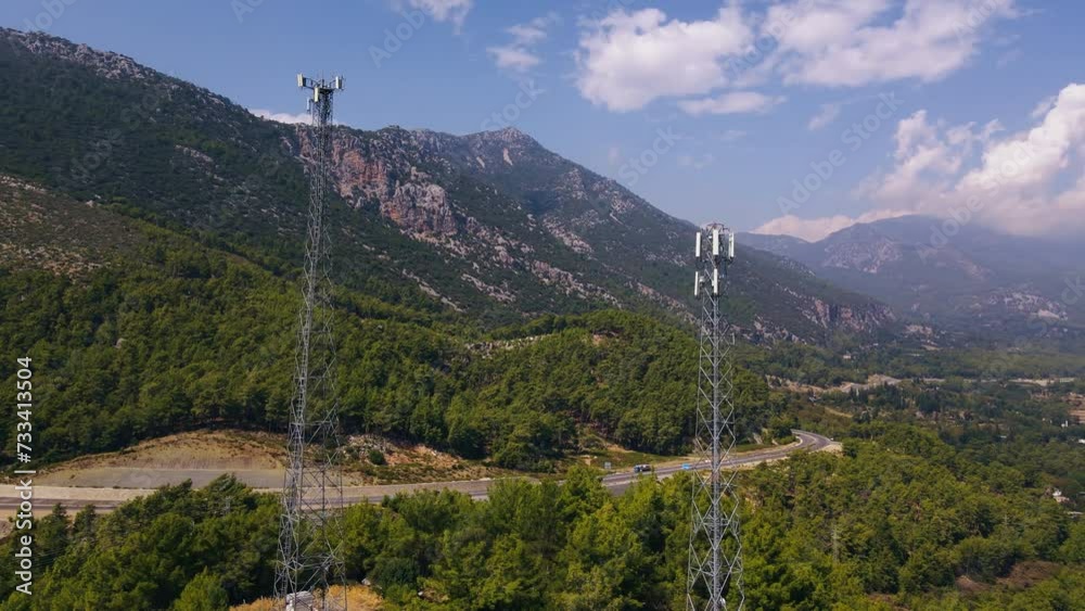 Wireless communication tower antenna in mountain location, satellite transmits the signals of cellular mobile signals. Aerial view