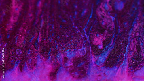 Glitter paint texture. Oil fluid flow. Defocused magenta pink blue color sparkling texture liquid ink water emulsion mix motion abstract art background.