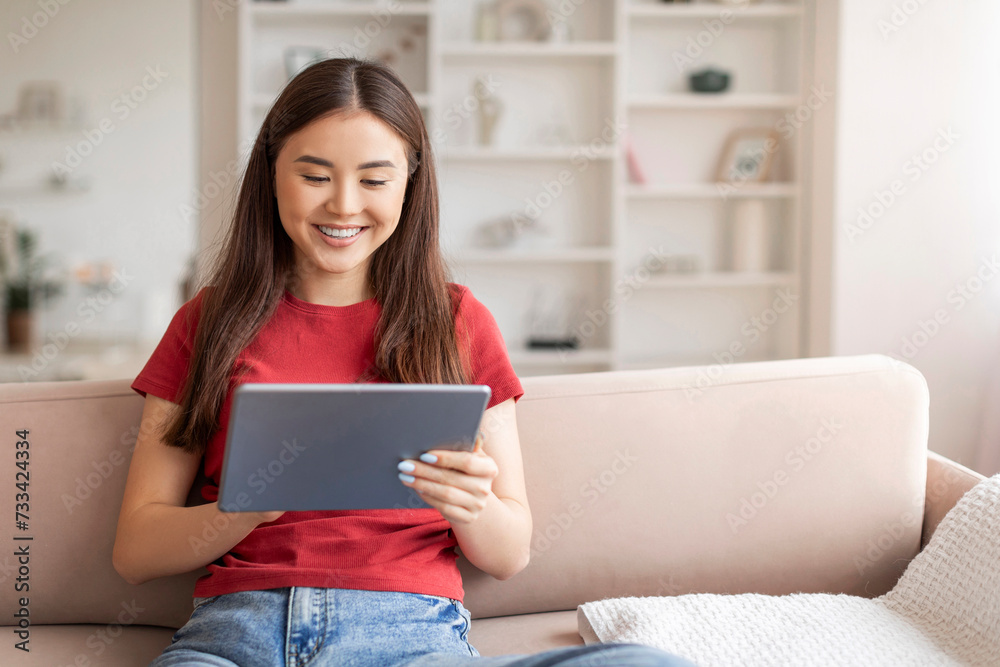Portrait Of Young Beautiful Asian Woman Resting On Couch With Digital Tablet Portrait Of Young Beautiful Asian Woman Resting On Couch With Digital Tablet