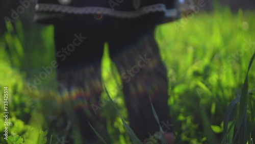 A child walking in green vegetation