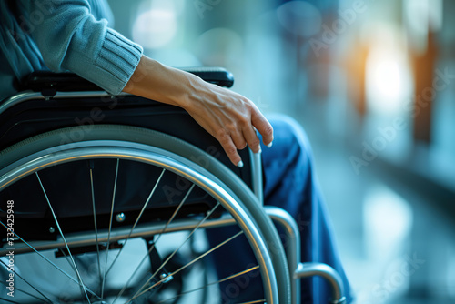 Male hand on wheelchair on blurred background