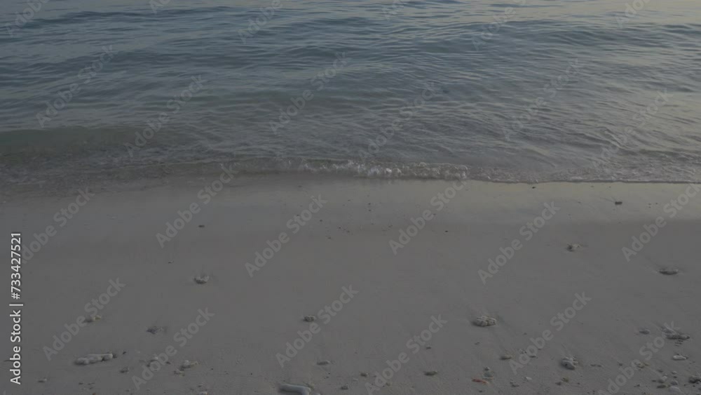 Durai Island, Anambas Islands, Indonesia while sunset with calm gentle wave hit the beach sands and sparkling sunlight reflection on the sea water surface. Concept for tropical island trip. Durai Island, Anambas Islands, Indonesia while sunset with calm gentle wave hit the beach sands and sparkling sunlight reflection on the sea water surface. Concept for tropical island trip.