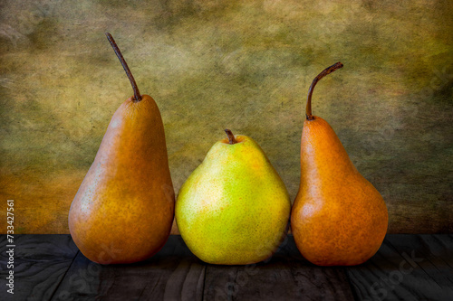 still life of a trio of pears with a textured background