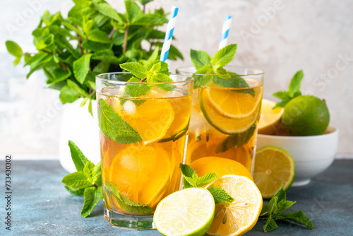 Iced tea. Summer drink with lemon, lime, mint and ice. Cold lemonade.