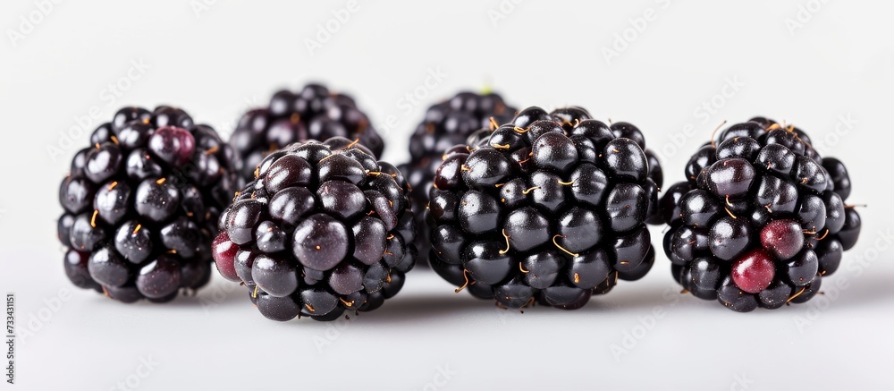 Isolated on a white surface, sweet blackberries are ripe. Isolated on a white surface, sweet blackberries are ripe.