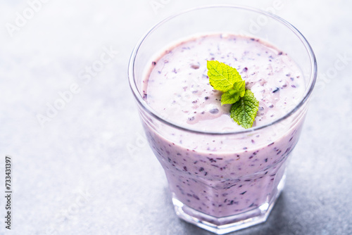 Blueberry smoothie or milkshake with fresh berries.
