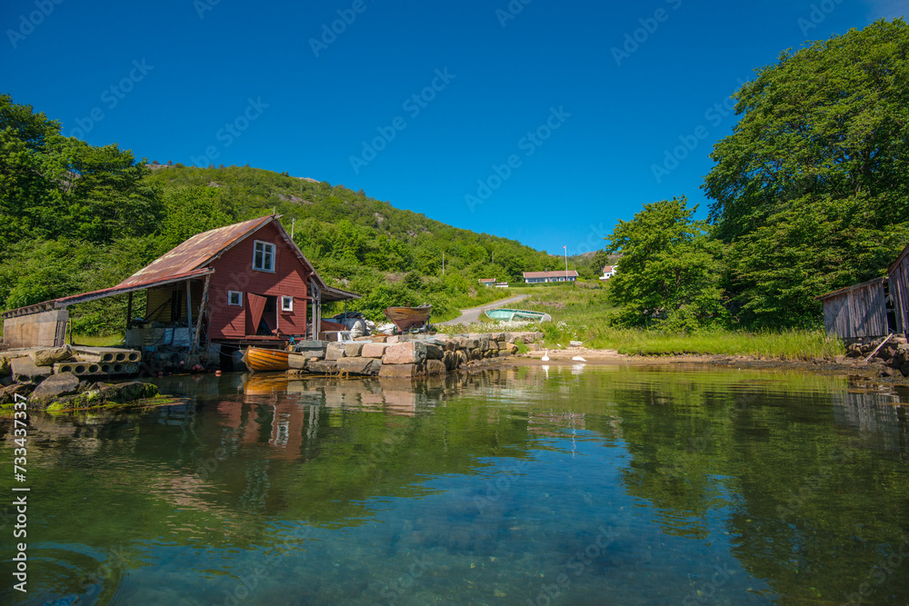 Fototapeta premium Old boat house and a small beach at summer.