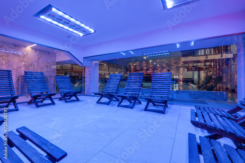 interior of modern wellness salt haloper cave with uv light with wooden bench photo
