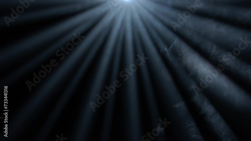 Studio shot of projector haze isolated on black background. Close up of blue light rays shining from top with smoke motion. photo