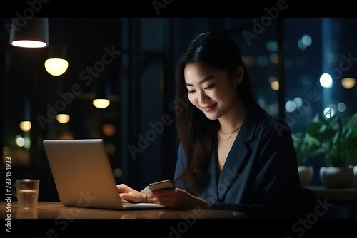Young happy asian business woman at work