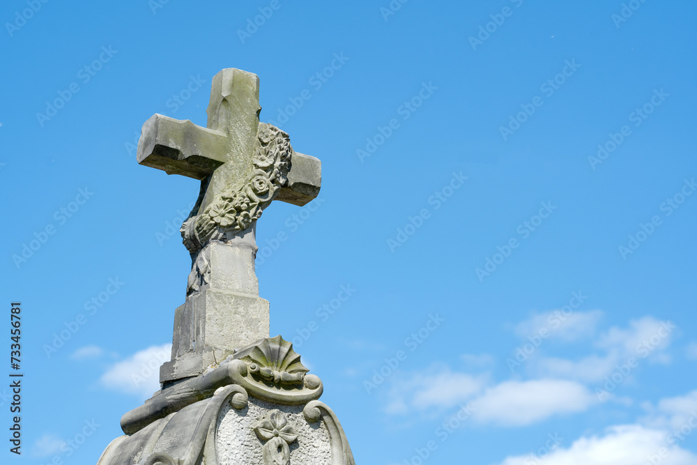 Old stone cross and light blue sky copy space simple abstract background, copy space. Old cemetery obelisk, Christianity, Catholicism symbols, faith concept, backdrop, wallpaper, nobody, no people