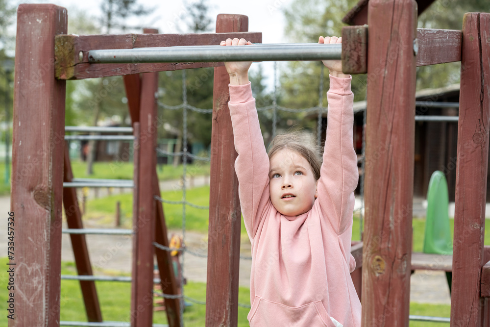 School age children two girls playing around on the playground, climbing, kids and fun physical exercise outdoors, sisters, siblings, hanging Strength and agility, young age, real people lifestyle School age children two girls playing around on the playground, climbing, kids and fun physical exercise outdoors, sisters, siblings, hanging Strength and agility, young age, real people lifestyle