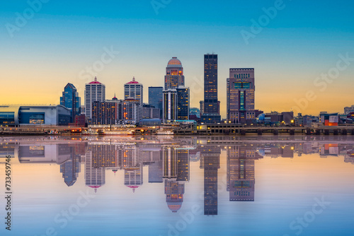 Beautiful sunset night view of Louisville Kentucky Skyline with river, bridge and lit buildings
