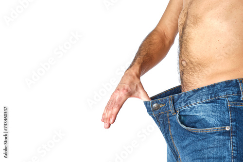 abdomen of man in profile with pants that are too big for having lost weight on white background photo
