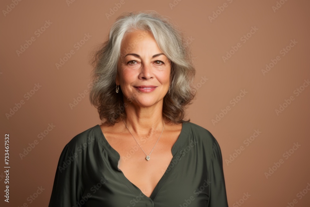 Portrait of a beautiful senior woman with short gray hair on a brown background Portrait of a beautiful senior woman with short gray hair on a brown background