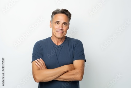 Handsome mature man in blue t-shirt on white background