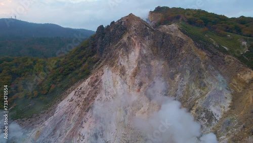 Cinematic aerial shot of geothermal steam vents in Jigokudani Hell Valley in Noboribetsu city in Hokkaido, Japan