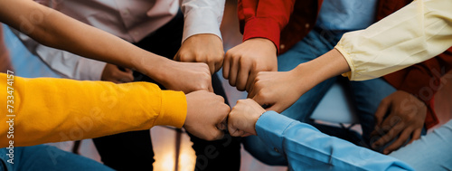 Startup company employee team stacking hand together symbolize successful group of business partnership and strong collective unity teamwork in community workplace in panoramic banner. Synergic © Summit Art Creations