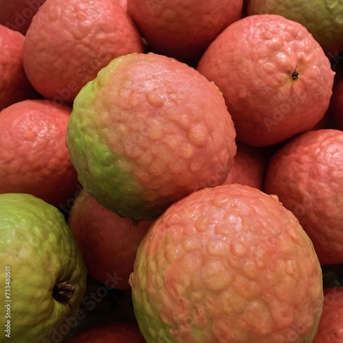 An up-close look at a cluster of ripe, vibrant guavas with intricate details