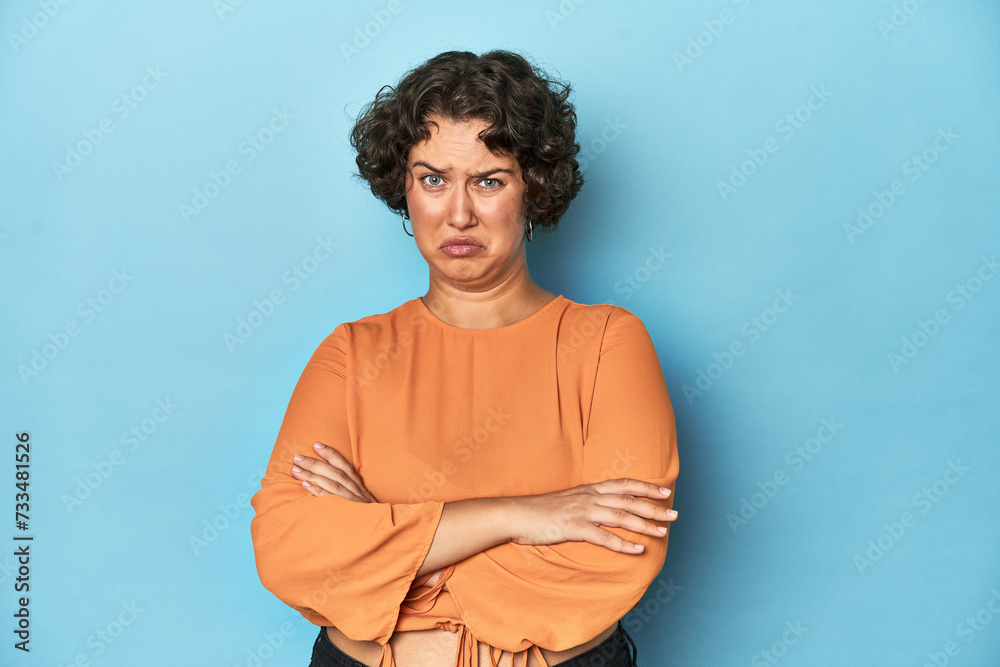 Young Caucasian woman with short hair unhappy looking in camera with sarcastic expression.