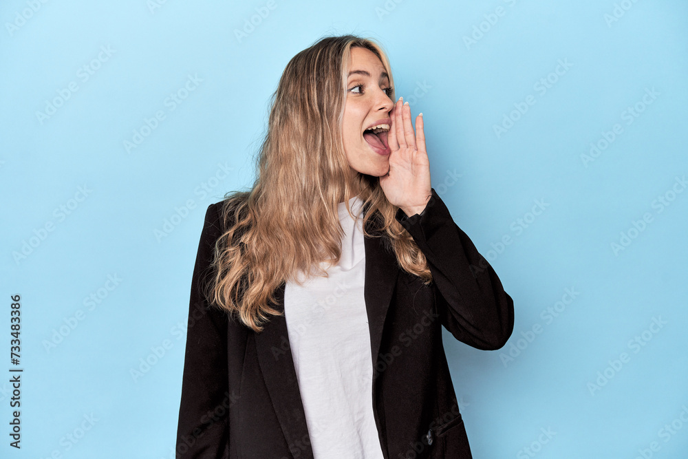 Caucasian woman in business jacket shouting and holding palm near opened mouth. Caucasian woman in business jacket shouting and holding palm near opened mouth.