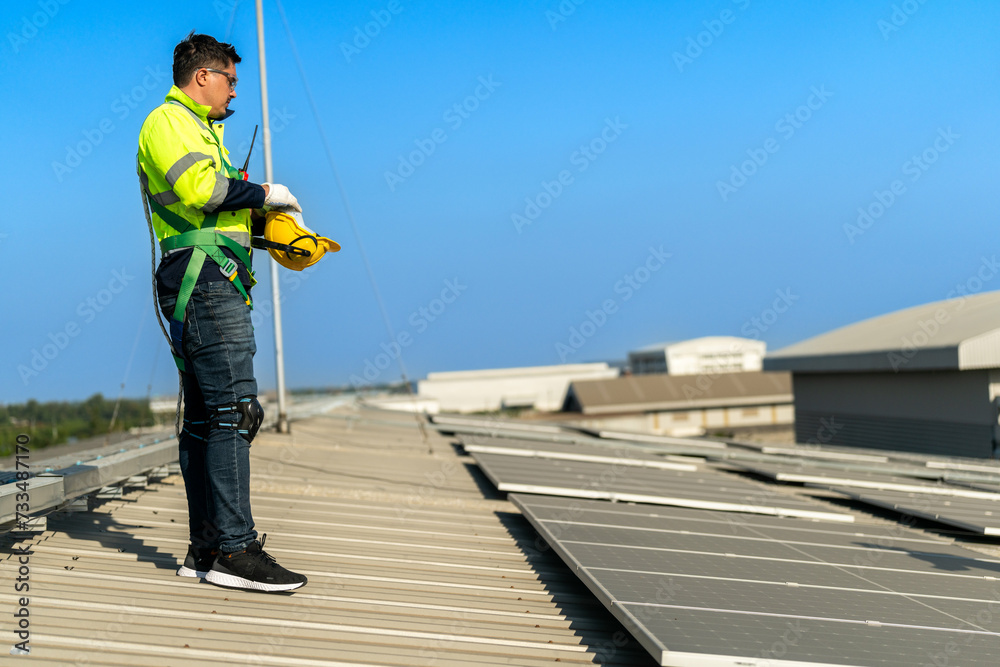 Worker Technicians are working to construct solar panels system on roof. Installing solar photovoltaic panel system. Alternative energy ecological concept. Renewable clean energy technology concept. Worker Technicians are working to construct solar panels system on roof. Installing solar photovoltaic panel system. Alternative energy ecological concept. Renewable clean energy technology concept.