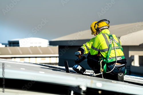 Worker Technicians are working to construct solar panels system on roof. Installing solar photovoltaic panel system. Alternative energy ecological concept. Renewable clean energy technology concept. photo