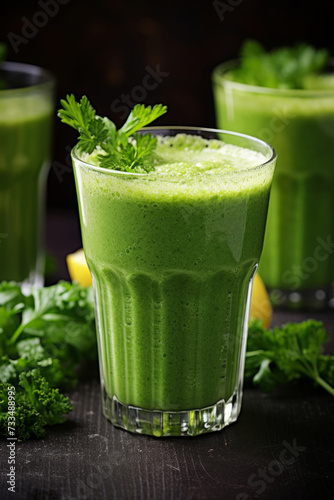 Green smoothie in glasses on dark background with various green vegetables and fruits