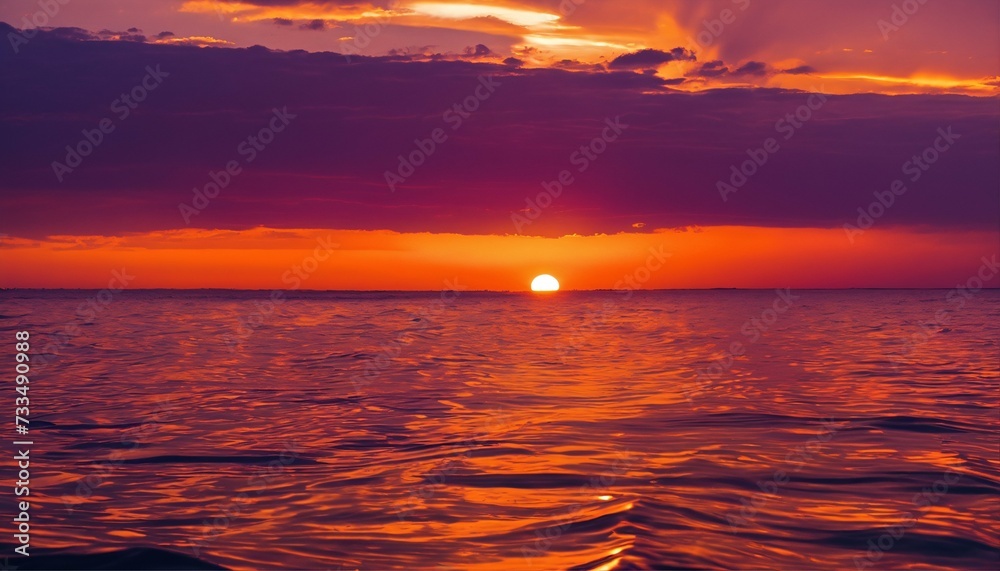 Boat's rear perspective of the sun setting on the sea, waves prominently in view
