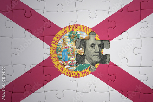 puzzle with the national flag of florida state and usa dollar banknote. finance concept photo