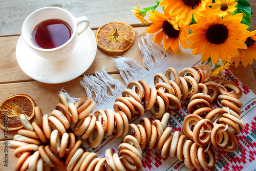 Sushki and tea cup on wooden background. Flat lay, top view. Russiand national traditions photo