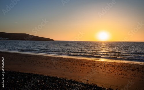 Beautiful vibrant sunrise  reflected in the Atlantic Ocean on the coast of Fuerteventura Island, Tarajalejo beach in Canary Islands