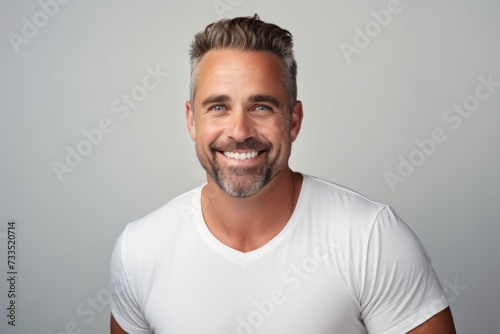 Portrait of a handsome smiling man in white t-shirt.