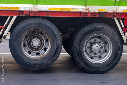 View of the rear wheels of a truck while driving with the rear axle raised photo