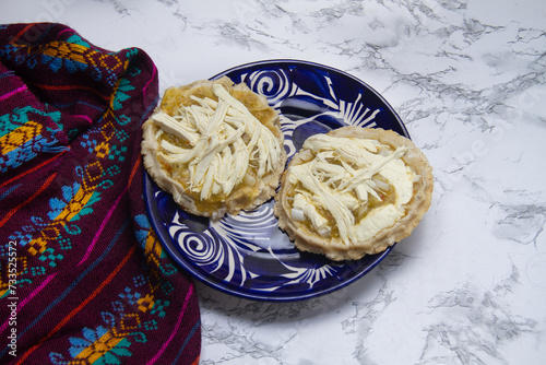 Flavorful Delight: Sopes with green sauce, cheese, and onion