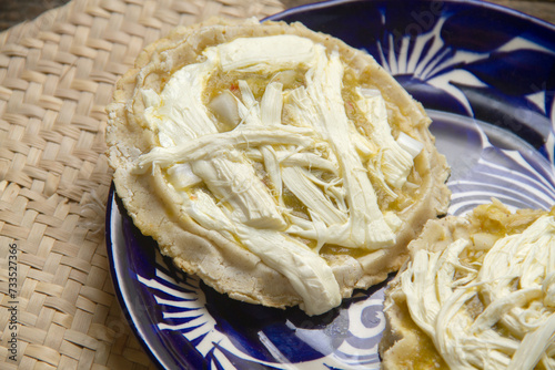 Flavorful Delight: Sopes with green sauce, cheese, and onion