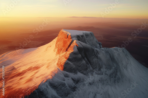 Aerial drone view of a snowy sandy mountain at sunrise © Astrognomo