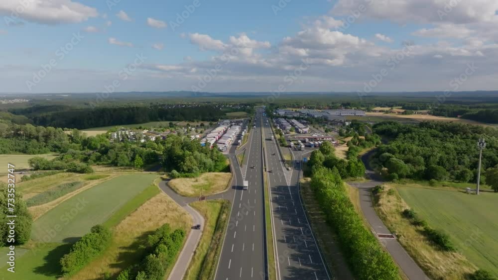 Drone advances over six-lane highway bathed in summer sunlight Drone advances over six-lane highway bathed in summer sunlight