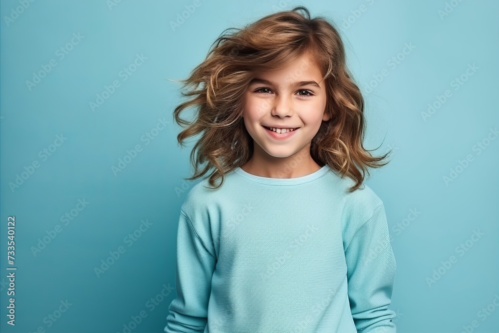 Portrait of a cute little girl with curly hair over blue background Portrait of a cute little girl with curly hair over blue background