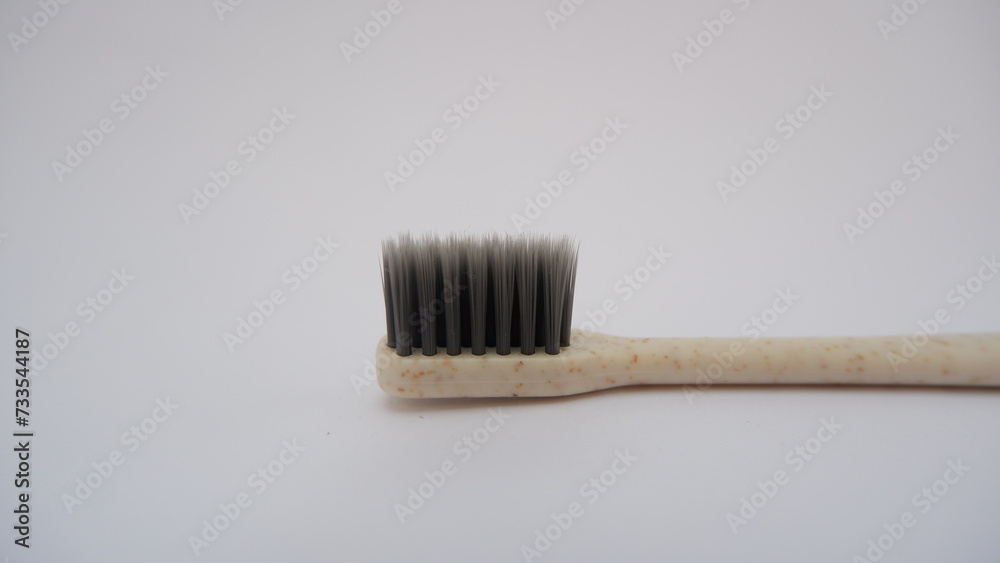 Close up toothbrush on white background. Gray toothbrush bristles. Selective focus. Teeth care concept. Close up toothbrush on white background. Gray toothbrush bristles. Selective focus. Teeth care concept.