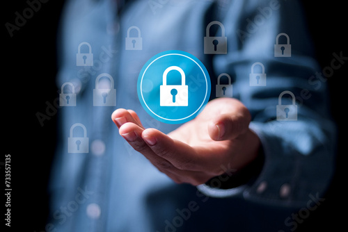 Protection network security and information security system concept, Person holding padlock icon on virtual screen. Information and cyber security technology services.