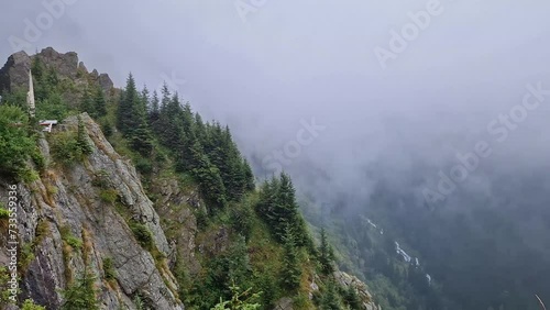 Wallpaper Mural Idyllic view to the foggy valley from the top of the mountain. Dense mist clouds above the carpathians pine forest Torontodigital.ca