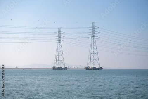 High-voltage transmission tower built on the sea where electricity flows 