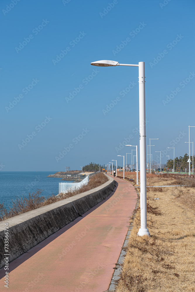 Walking path and street lights by the sea
